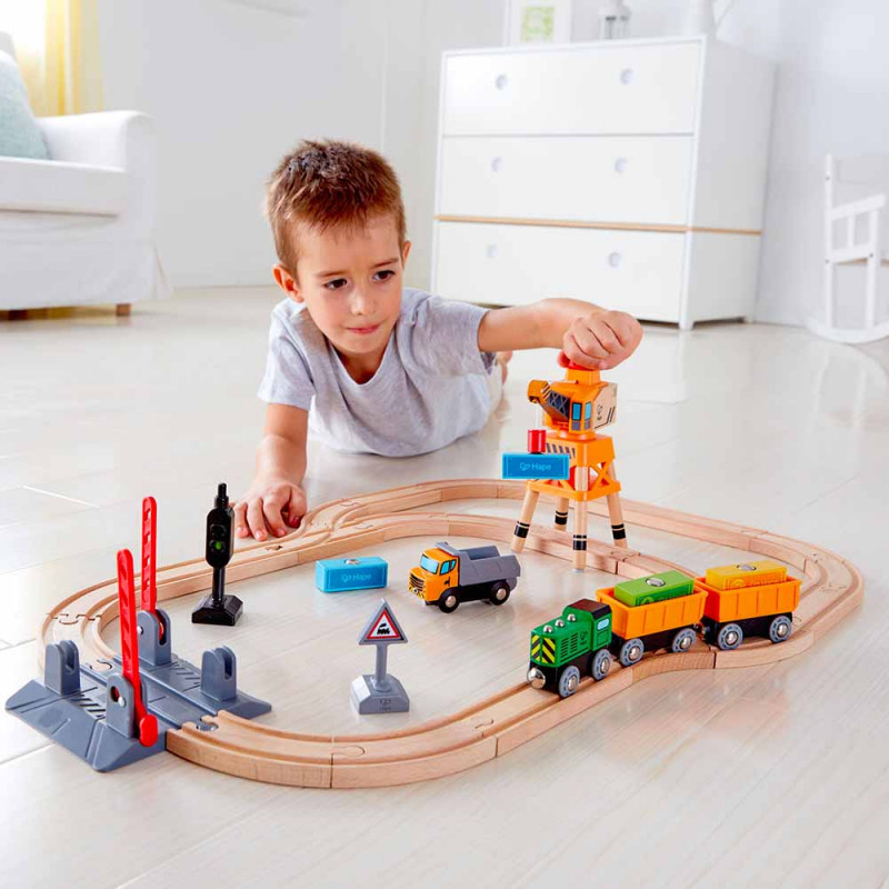 Enfant qui joue avec circuit train cargo bois (dès 3 ans)